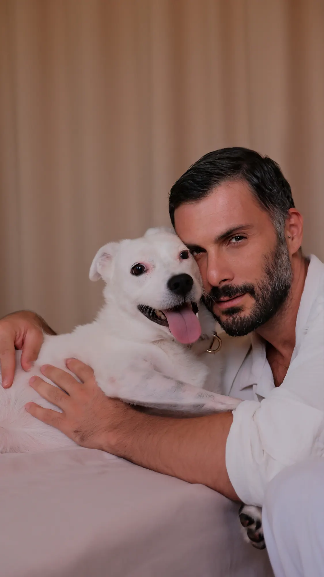 Tarik Gül with his dog, sharing a quiet moment at home.